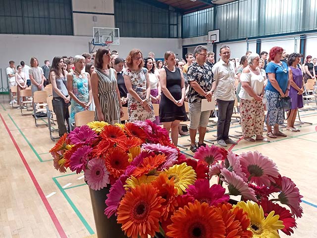 Profesorji in dijaki stojijo ob poslušanju maturantske himne Gaudemus igitur.